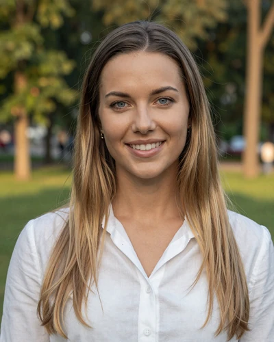 Weronika, 27-year-old Polish woman from Warsaw with dark blonde hair smiling in a city park