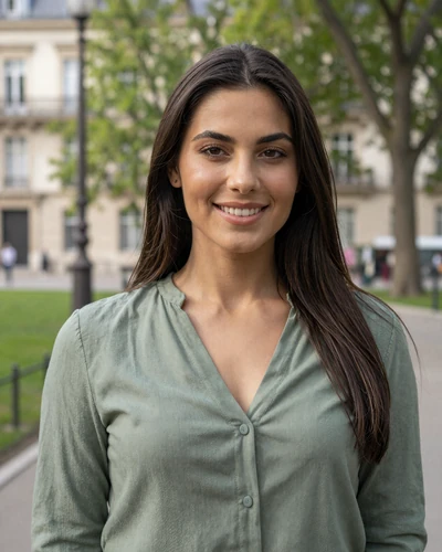Ioana, 27-year-old Romanian woman from Bucharest with dark brown hair smiling warmly in a city park