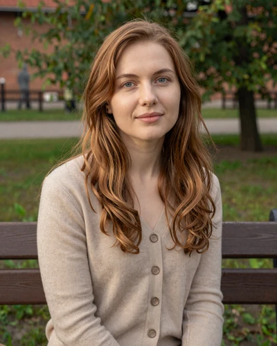 Yuliya, 27-year-old Belarusian woman from Brest with auburn hair sitting in a memorial park