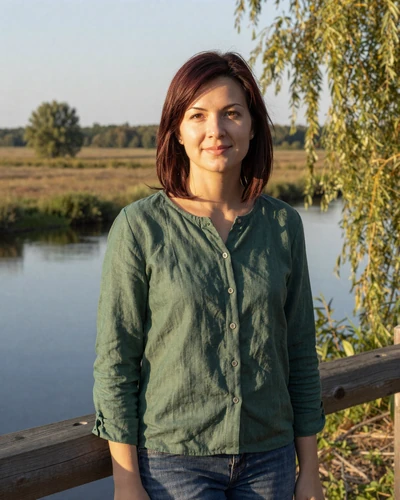 Hanna, 30-year-old Belarusian woman from Pinsk with dark auburn hair near a river with marshlands