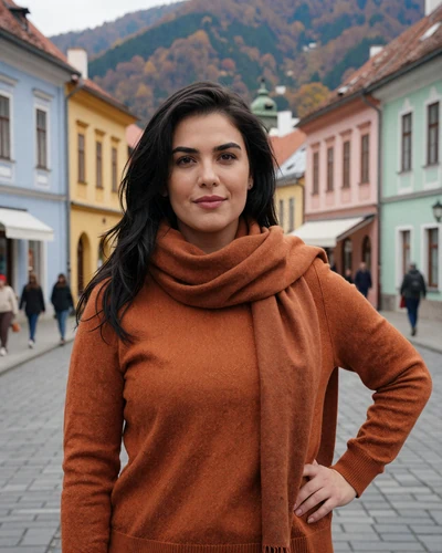 Cristina, 33-year-old Romanian woman from Brașov with dark hair in front of Carpathian mountain backdrop