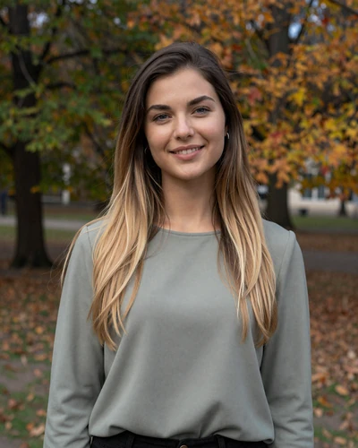 Klára, 27-year-old Czech woman from Prague with dark blonde hair smiling in an autumn park
