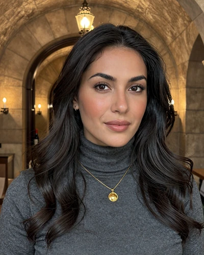 Kata, 30-year-old Hungarian woman from Eger with black hair wearing a charcoal turtleneck by a wine cellar